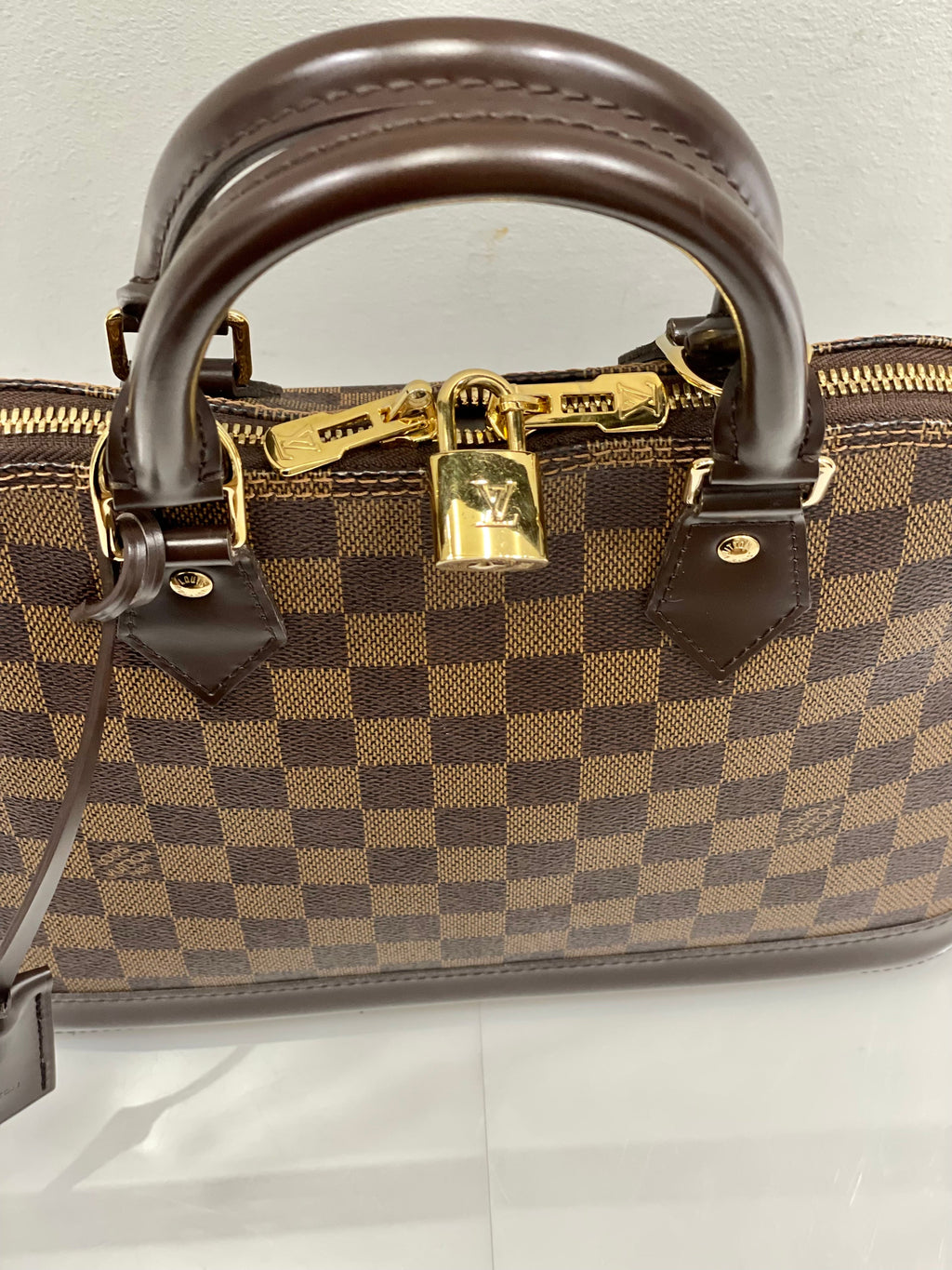 LOUIS VUITTON DAMIER EBENE ALMA PM HANDBAG