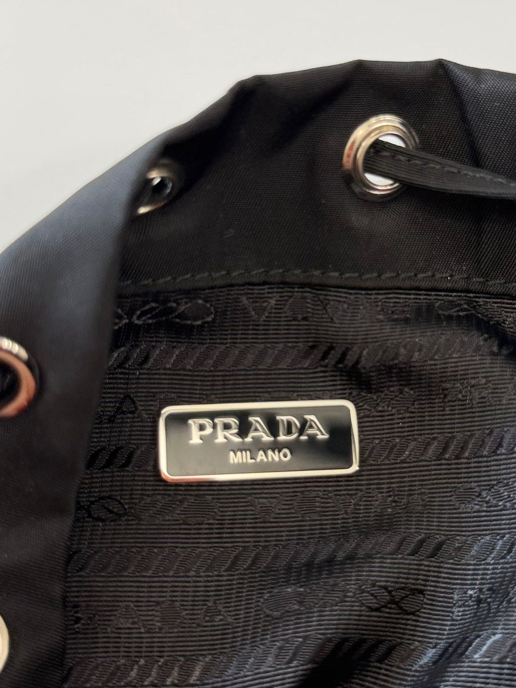 PRADA RE-NYLON TRIANGLE LOGO PLAQUE BUCKET POUCH WRISTLET