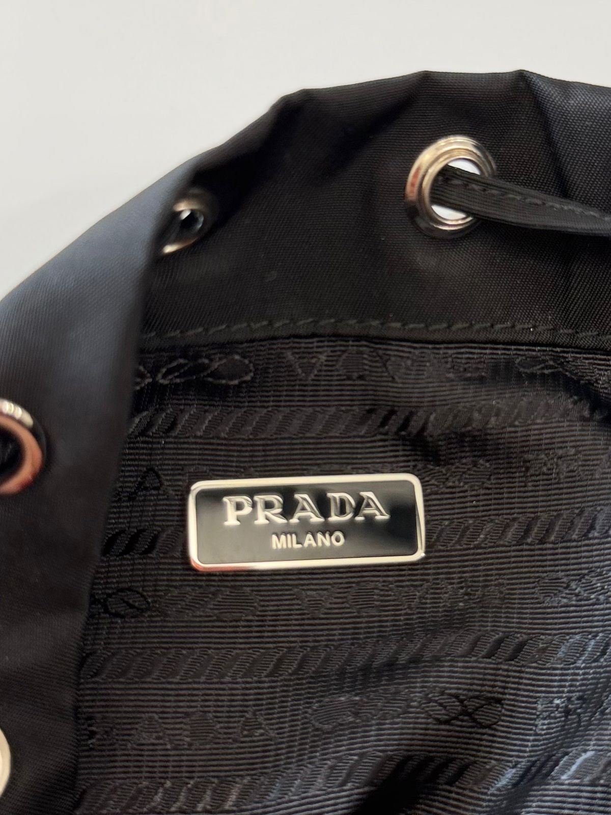 PRADA RE-NYLON TRIANGLE LOGO PLAQUE BUCKET POUCH WRISTLET