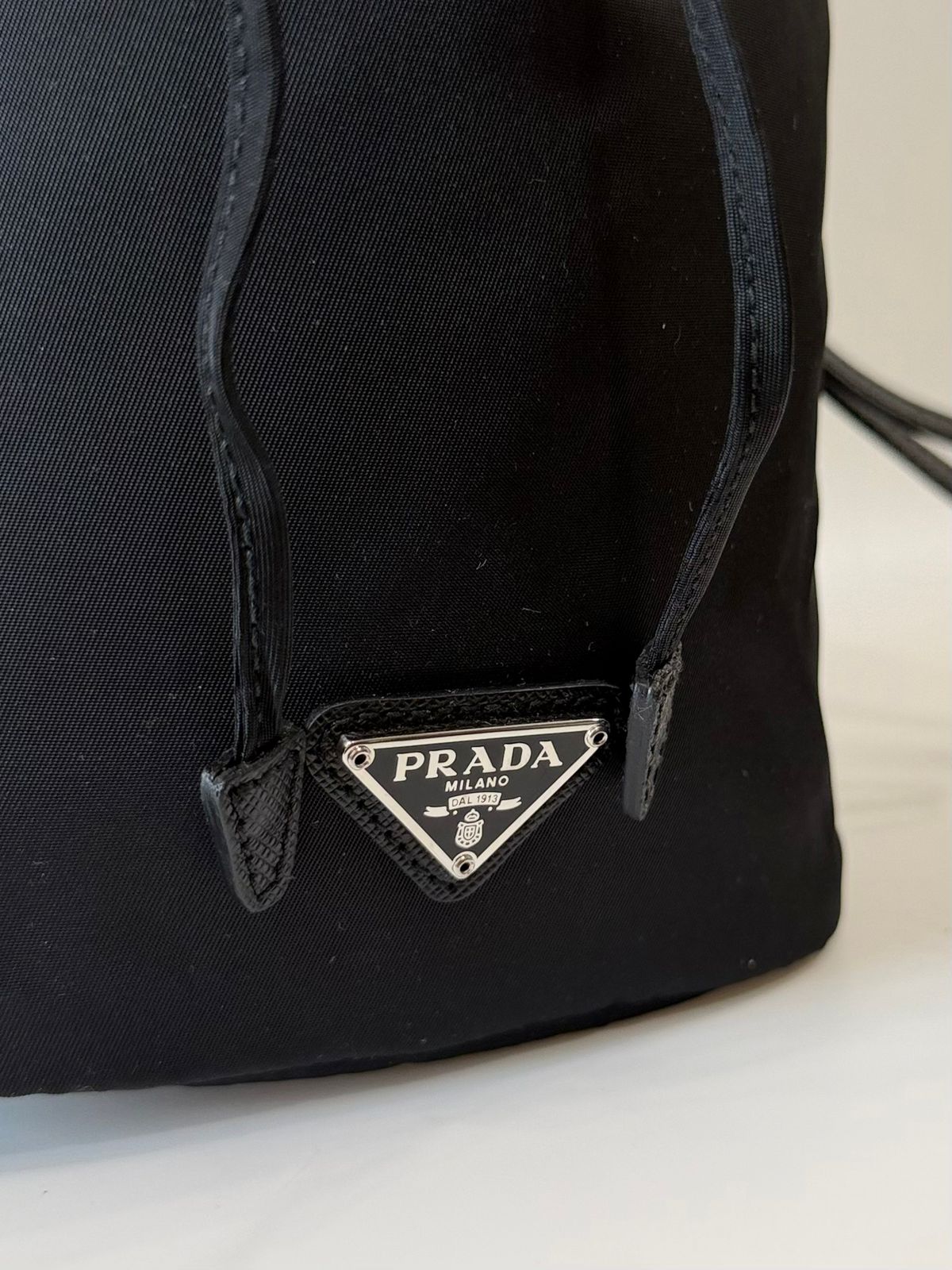 PRADA RE-NYLON TRIANGLE LOGO PLAQUE BUCKET POUCH WRISTLET